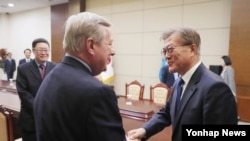 문재인 한국 대통령(오른쪽)이 지난달 31일 한국을 방문한 더빈 미국 민주당 상원 원내총무와 만나 악수하고 있다.