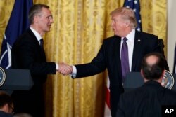 President Donald Trump shakes hands with NATO Secretary General Jens Stoltenberg during a news conference in the East Room of the White House, April 12, 2017, in Washington.