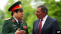 U.S. Defense Secretary Leon Panetta, right, speaks with Vietnamese Defense Minister Phung Quang Thanh during an arrival ceremony at the Ministry of Defense in Hanoi, Vietnam Monday, June 4, 2012. (AP Photo/Jim Watson, Pool)