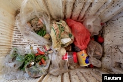 Food is stored in a broken refrigerator belonging to 18-member Ruzaiq family who live next to a garbage dump where they collect recyclables and food near the Red Sea port city of Hodeidah, Yemen, Jan. 16, 2018.