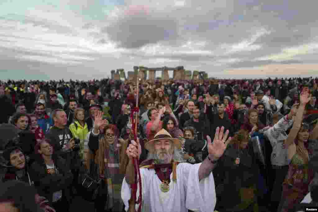 Revelers celebrate the summer solstice at Stonehenge on Salisbury Plain in southern England, Britain.