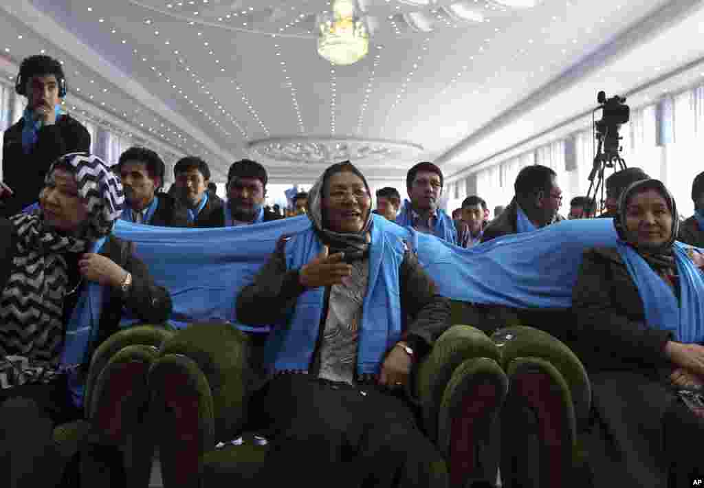 The deeply conservative, all-male crowd at Afghanistan&#39;s Kandahar stadium watch as vice-presidential candidate, Habiba Sarabi, in a headscarf stood up and reached for the microphone, Kabul, March 17, 2014. 