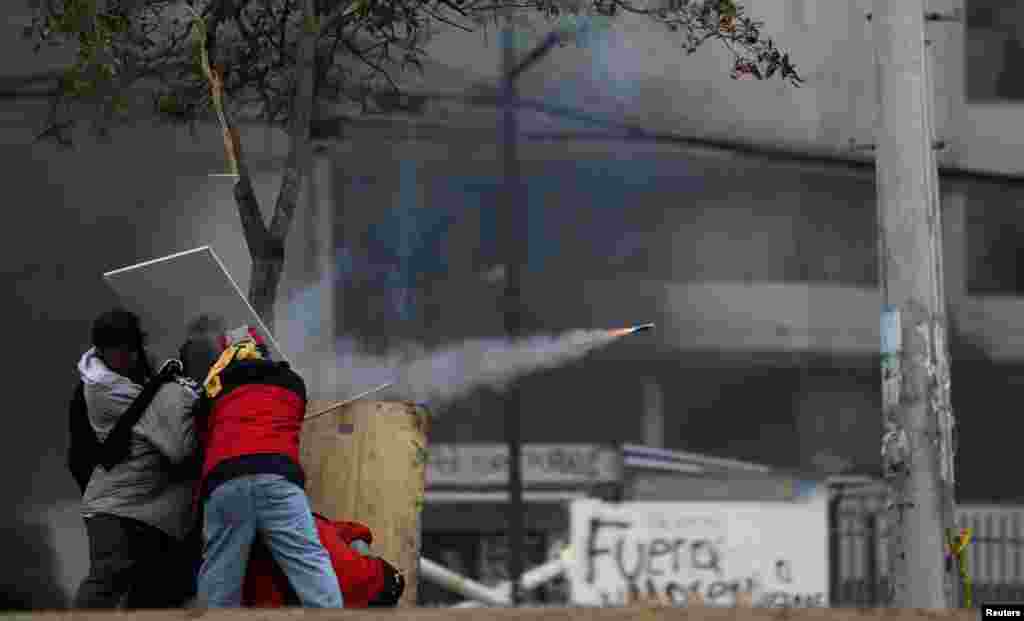 Demonstrators fire a homemade weapon during a protest against Ecuador&#39;s President Lenin Moreno&#39;s austerity measures, in Quito, Oct. 13, 2019.
