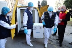 Medical workers receive the first shipment of Pfizer-BioNTech COVID-19 vaccines in Belgrade, Serbia, December 22, 2020. REUTERS