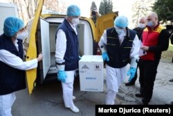 Medical workers receive the first shipment of Pfizer-BioNTech COVID-19 vaccines in Belgrade, Serbia, December 22, 2020. REUTERS