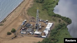 FILE - Aerial view of an oil exploration site in Bulisa district, approximately 244 km (152 miles) northwest of Kampala, undated handout photo from Tullow Oil Uganda, July 4, 2012.