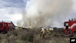 Rescue workers and firefighters are seen at the site where an Aeromexico airliner has suffered an "accident" in a field near the airport of Durango, Mexico, July 31, 2018.