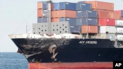 In this photo released by Japan's 3rd Regional Coast Guard Headquarters, the damage of Philippine-registered container ship ACX Crystal is seen in the waters off Izu Peninsula, southwest of Tokyo, after it had collided with the USS Fitzgerald, June 17, 20