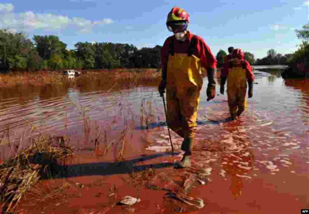 Rescue team searches for missing bodies possibly washed away by flooding toxic mud near the village of Kolontar, Hungary, Thursday, Oct. 7, 2010. Monday's flooding was caused by the rupture of a red sludge reservoir at a metals works in western Hungary an