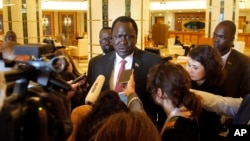 FILE - South Sudan's Minister of Petroleum Ezekiel Lol Gatkuoth speaks to reporters in the lobby of his residence hotel in Jiddah, Saudi Arabia, May 18, 2019. 