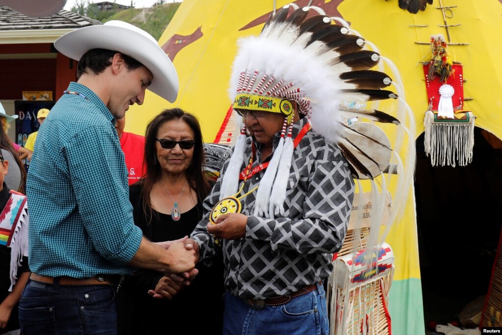 在卡加利牛仔节（Calgary Stampede），加拿大总理特鲁多和印第安人握手（2017年7月15日）。卡加利牛仔节是每年7月在加拿大亚伯达省卡加利（简称卡城）举行的博览会和牛仔竞技，为期十日，年度入场人数超过100万人次。