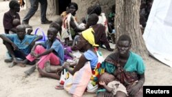 FILE - Residents displaced by fighting between government and rebel forces are seen at a World Food Program (WFP) outpost in Kuernyang Payam, South Sudan, May 2, 2015. 