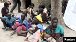 FILE - Residents displaced by fighting between government and rebel forces are seen at a World Food Program outpost in Kuernyang Payam, South Sudan May 2, 2015. 