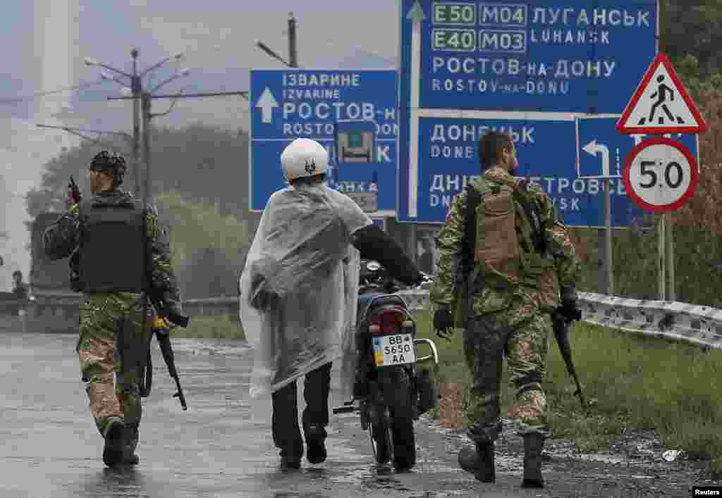 Ukrainian servicemen detain a local resident near a checkpoint in Debaltseve, Ukraine, Sept. 9, 2014.