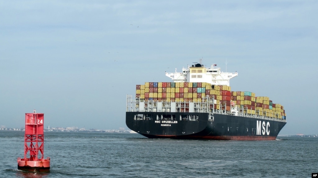 FILE - A container ship makes its way into the Port of Charleston in Charleston, S.C., May 20, 2014.