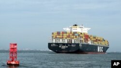 FILE - A container ship makes its way into the Port of Charleston in Charleston, S.C., May 20, 2014.