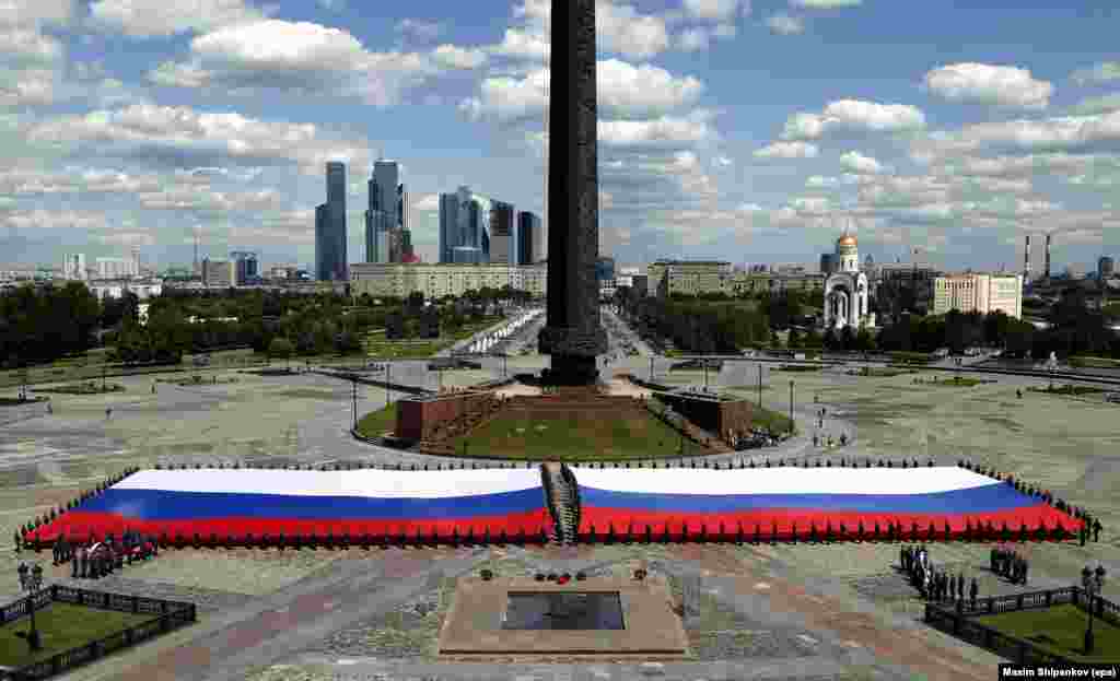 Cadets of the high school of the Russian Emergencies Ministry hold what is said to be the largest flag of Russia, at the Poklonnaya hill, marking the upcoming 'Day of Russia' celebration, in Moscow.