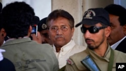 FILE - Pakistan's former president and military ruler Pervez Musharraf, center, is seen after appearing in court in Rawalpindi, April 17, 2013. 