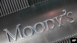 FILE - This Aug. 2010 file photo shows a sign for Moody's Corp. in New York. Concerns are building from Washington to Wall Street about the trillions of dollars in debt that U.S. businesses have racked up. 