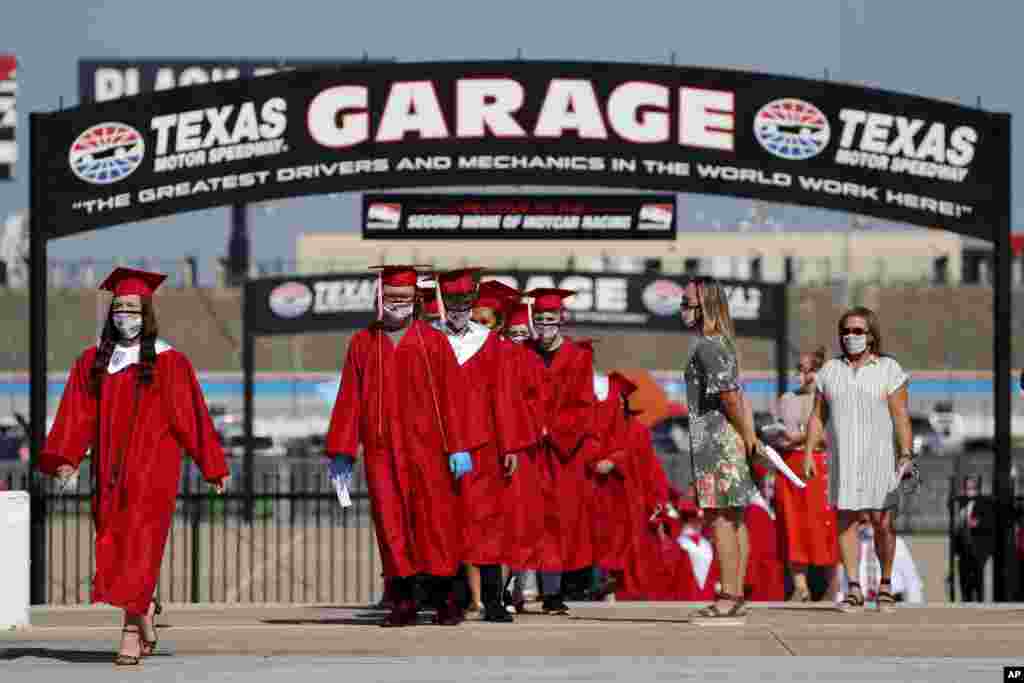 Ponder High School students take part in their graduation ceremony at Texas Motor Speedway in Fort Worth, Texas, May 19, 2020.