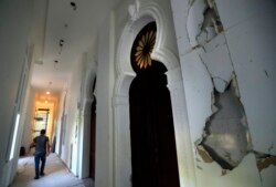 A worker walks in a corridor of the Sursock Museum that is still under reconstruction a year after being damaged in the massive explosion at the nearby port, in Beirut, Lebanon. The art collection was badly hit. (AP Photo/Hussein Malla)