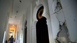 A worker walks in a corridor of the Sursock Museum that is still under reconstruction a year after being damaged in the massive explosion at the nearby port, in Beirut, Lebanon. The art collection was badly hit. (AP Photo/Hussein Malla)