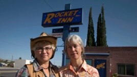 Val Wilkes, 54, (L) and her wife Cydney Wilkes, 56, stand outside their motel, the Rocket Inn, in Truth or Consequences, New Mexico May 2, 2014. (REUTERS/Lucy Nicholson)