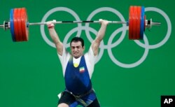 Sohrab Moradi, of Iran, competes in the men's 94kg weightlifting competition at the 2016 Summer Olympics in Rio de Janeiro, Brazil, Aug. 13, 2016.
