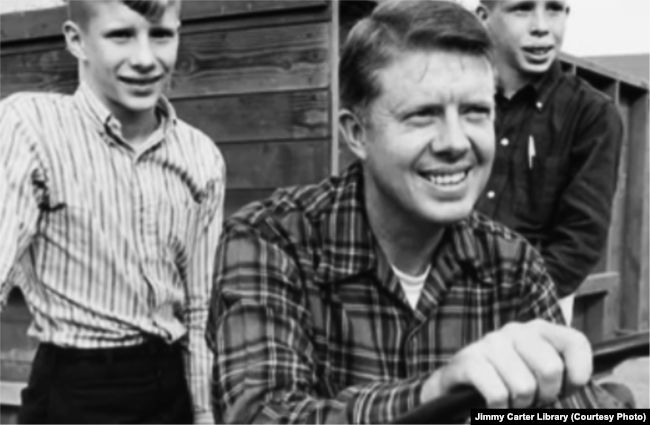 Jimmy Carter and two of his sons at the family farm. Jimmy and Rosalynn went on to have a daughter as well. (Courtesy of Jimmy Carter Library)