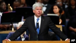 Michigan Gov. Rick Snyder speaks during the funeral service for Aretha Franklin at Greater Grace Temple, Aug. 31, 2018, in Detroit. Snyder signed lame-duck legislation Friday to scale back minimum wage a paid sick leave laws that began as citizen initiatives.