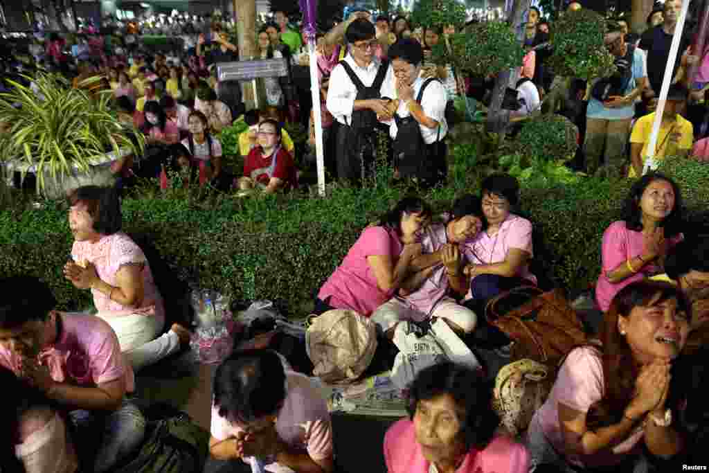 Warga menangis setelah mendengar pengumuman mangkatnya Raja Thailand Bhumibol Adulyadej, di rumah sakit Siriraj, Bangkok (13/10). (Reuters/Athit Perawongmetha)