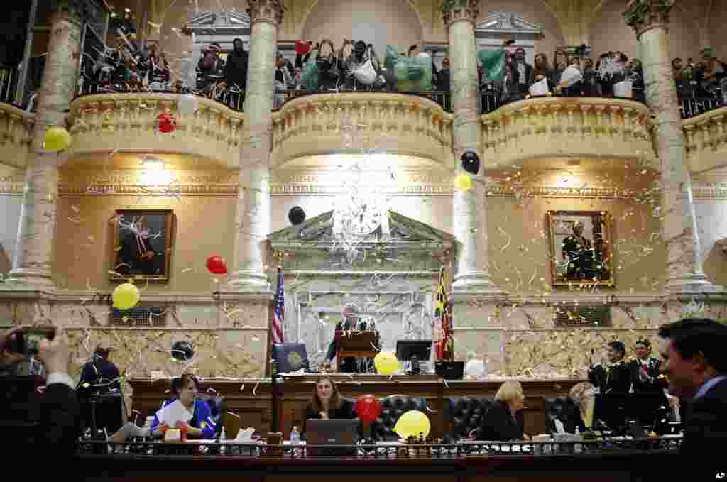 Pages drop confetti and balloons from a balcony in the Maryland House of Delegates chamber in Annapolis, Maryland, USA, to celebrate the end of the state&#39;s 2018 legislative session.
