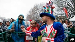 FILE -Patrick Bettis, of Glen Ellyn, Ill., a promoter of marijuana legalization, hands a joint to Larnell Rhea, of Denver, during the Mile High 420 Festival in Denver,April 20, 2018. 