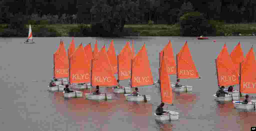 Children learn to sail on the Galgenweel lake in Antwerp, Belgium.