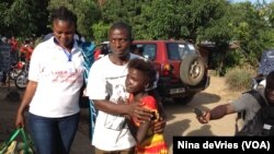 Kadiatu Bangura embraces her brother Emmanuel after being discharged from the Ebola Red Cross Treatment Center, Lumpa community, near Freetown, Sierra Leone, Sept. 27, 2014.