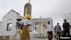 Worshipers arrive at Holy Trinity Catholic Church in Nigeria's capital, Abuja, June 24, 2012. 
