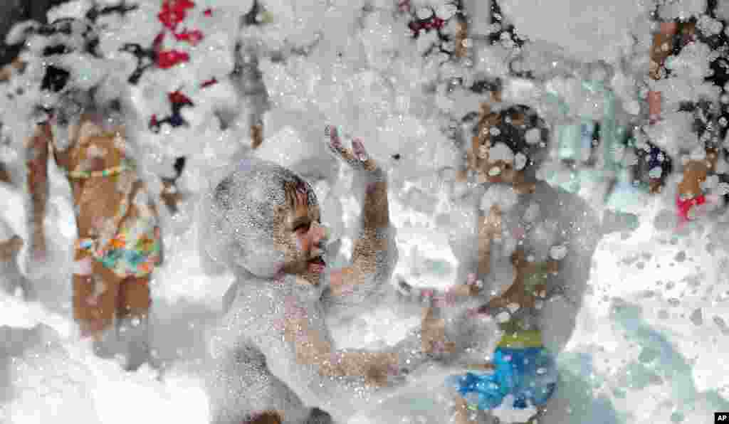 Children play with soap foam bubbles during the fair in honor of &quot;Nuestra Senora de los Angeles&quot; in the village of Las Pinedas near of Cordoba, Spain.