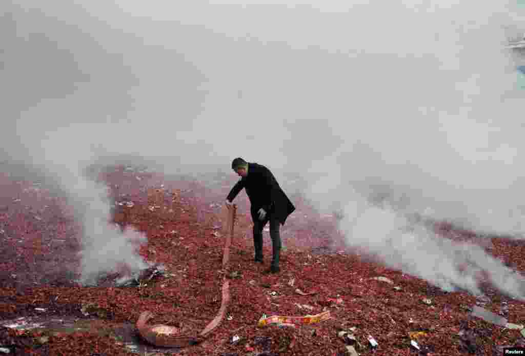 A man holds firecrackers during the opening of a wholesale market in Harbin, Heilongjiang province, China.