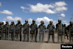 Venezuelan National guards block the road at the border between Venezuela and Brazil in Pacaraima, Roraima state, Brazil, Feb. 22, 2019.