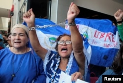 An anti-government protester shouts slogans to riot police during a protest against Nicaraguan President Daniel Ortega's government in Managua, Nicaragua, March 30, 2019.