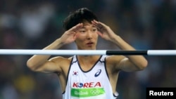 Woo Sang-hyuk of South Korea reacts in the men's high jump qualifying round during the Olympic Games in Rio de Janeiro, Brazil, Aug. 14, 2016.