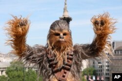 A person wearing a costume of the character Chewbacca poses for photographers at the photo call of the film 'Solo: A Star Wars Story' in London, May 18, 2018.