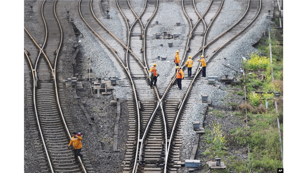 Workers inspect railway tracks, which serve as a part of the Belt and Road freight rail route linking Chongqing to Duisburg, at Dazhou railway station in Sichuan province, China, March 14, 2019.