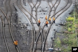 Workers inspect railway tracks, which serve as a part of the Belt and Road freight rail route linking Chongqing to Duisburg, at Dazhou railway station in Sichuan province, China, March 14, 2019.