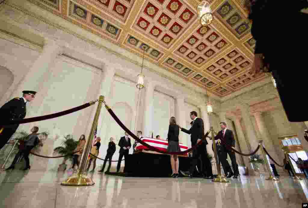 Law clerks are relieved by the next team of law clerks as they stand vigil while members of the public walk through the Great Hall of the Supreme Court in Washington, where late Supreme Court Justice Antonin Scalia lies in repose, Feb. 19, 2016.