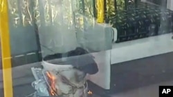 This is an image made from video showing burning items in underground train at the scene of an explosion in London, Sept. 15, 2017.