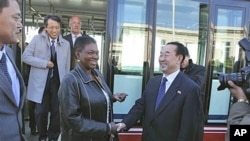 U.N. humanitarian chief Valerie Amos, center left, shakes hands with North Korean Deputy Foreign Minister Pak Kil Yon on her arrival at Pyongyang airport, October 17, 2011.