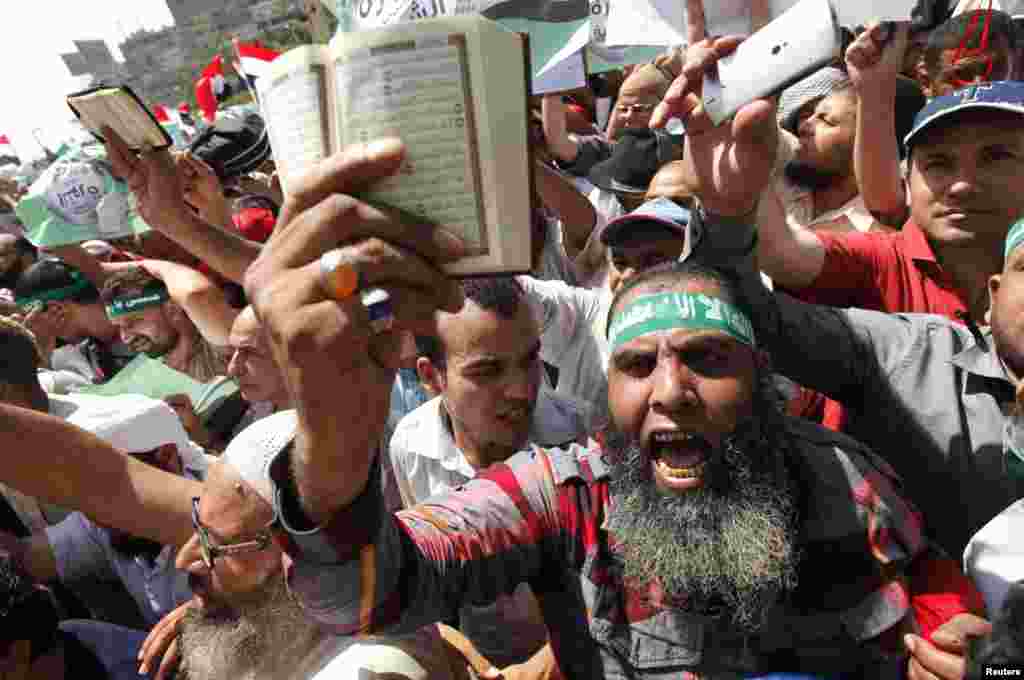 Islamists and supporters of Egyptian President Mohamed Morsi shout slogans during a protest around the Raba El-Adwyia mosque square in the suburb of Nasr City, Cairo, June 28, 2013. 