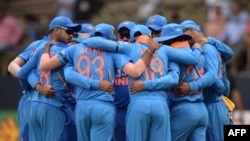 FILE - Indian team forms a huddle prior to the start of a cricket match between India and Australia at the M. Chinnaswamy Stadium in Bangalore on January 19, 2020. (Photo by Manjunath KIRAN / AFP)