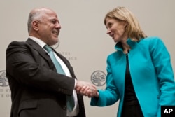 Prime Minister of Iraq Haider al-Abadi shakes hands with Nancy Lindborg, president of the United States Institute of Peace, after speaking at the institute in Washington, March 20, 2017.